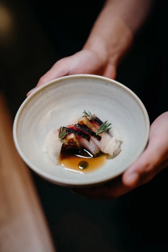 Seared kingfish with seasonal herbs and broth – modern Australian fine dining at Peonee Restaurant in Canberra.